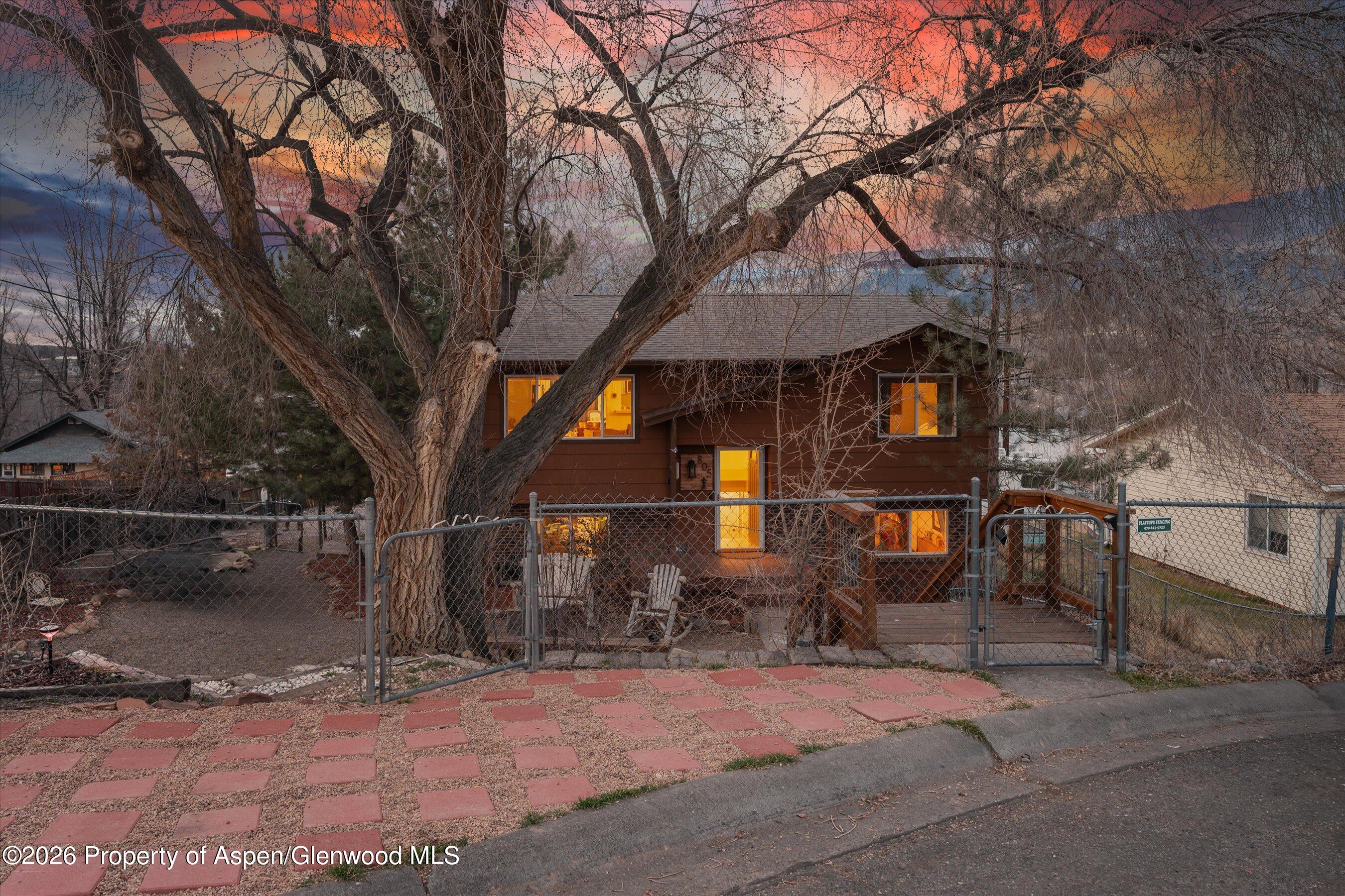 805 Munro Avenue Rifle, CO 81650 - Photo 23 of 23 a street view with wooden fence and a bench