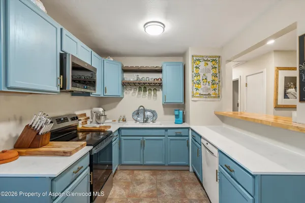 a kitchen with a sink a stove and cabinets