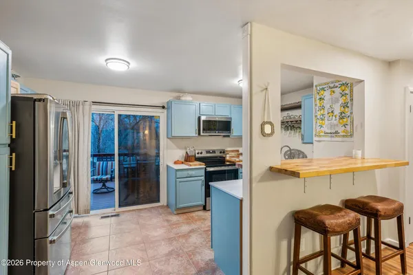a kitchen with stainless steel appliances granite countertop a refrigerator and a stove top oven