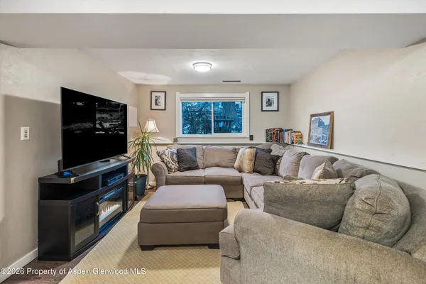 a living room with furniture and a flat screen tv