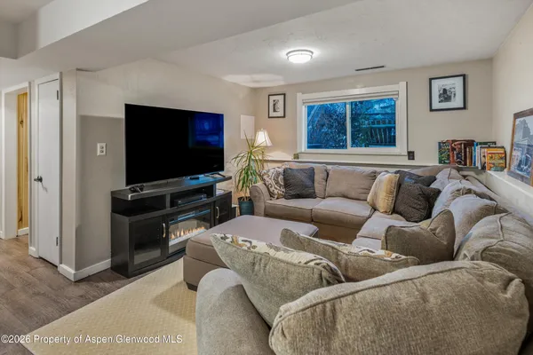 a living room with furniture and a flat screen tv