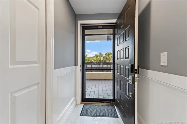a living room with furniture and a painting on the wall