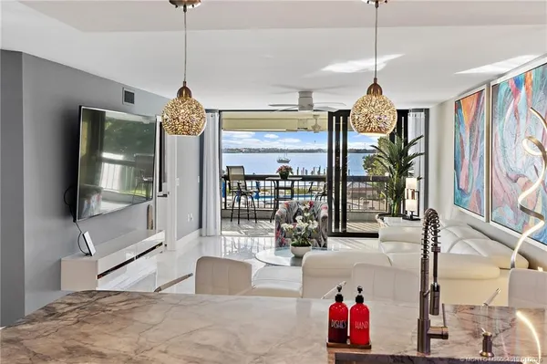 a very nice looking room with a large window and chandelier