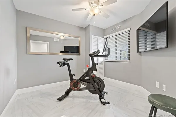 a view of a dining room with furniture a chandelier and wooden floor