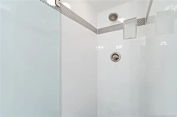 a view of a hallway with wooden floor and a potted plant