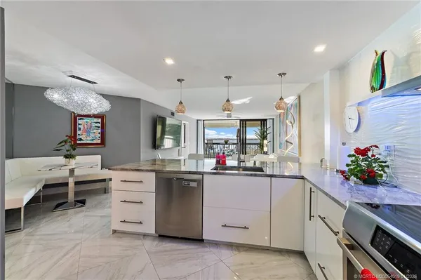 a living room with furniture and kitchen view