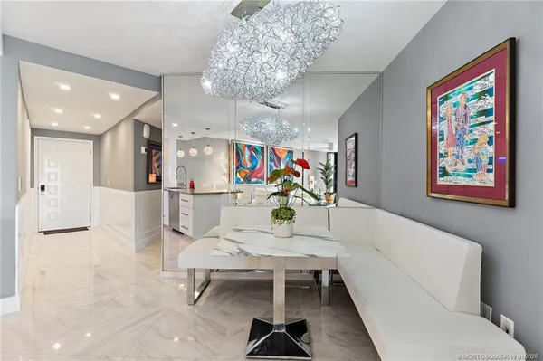 a living room with furniture and a chandelier