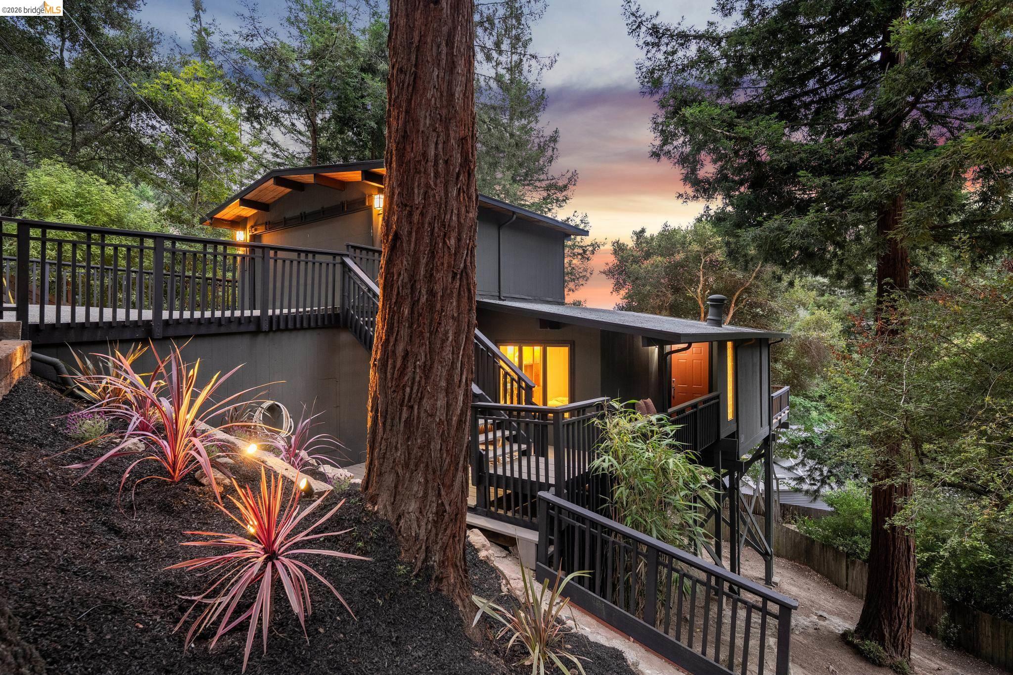 6645 Heather Ridge Way Oakland, CA 94611 - Photo 59 of 61 Multi-level home featuring dark gray siding and a black railing system