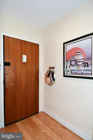 a view of a hallway with wooden floor