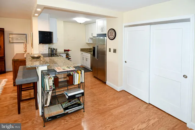a kitchen with stainless steel appliances a stove top oven and a refrigerator