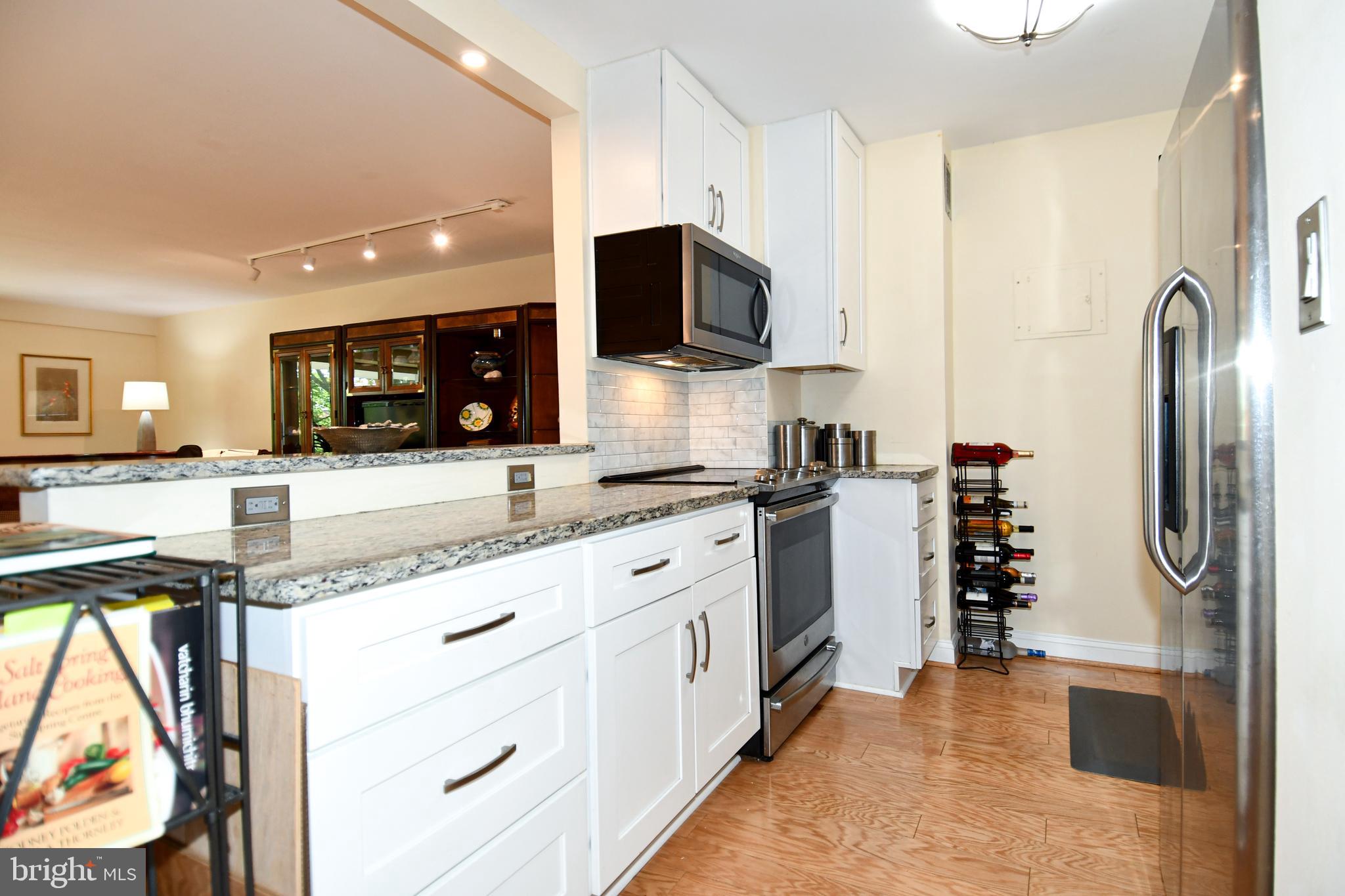 1435 4th Street Southwest, Unit B108 Washington, DC 20024 - Photo 6 of 57 a kitchen with stainless steel appliances granite countertop a refrigerator and a sink