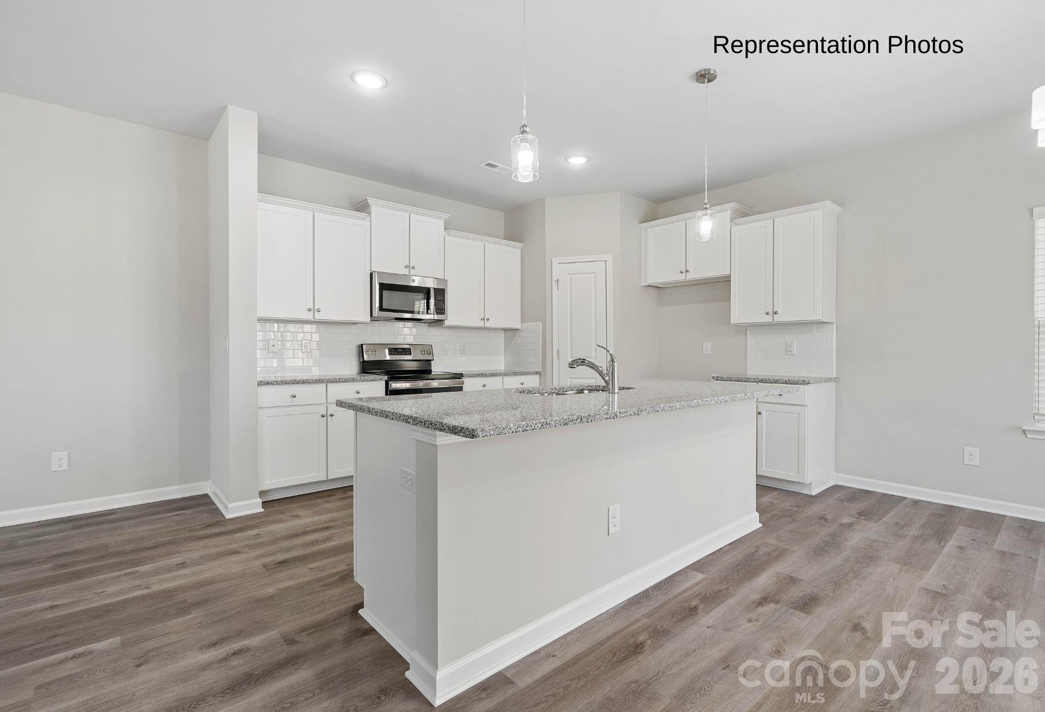 111 Pinnacle Crossing Shelby, NC 28152 - Photo 5 of 24 a kitchen with granite countertop white cabinets and stainless steel appliances
