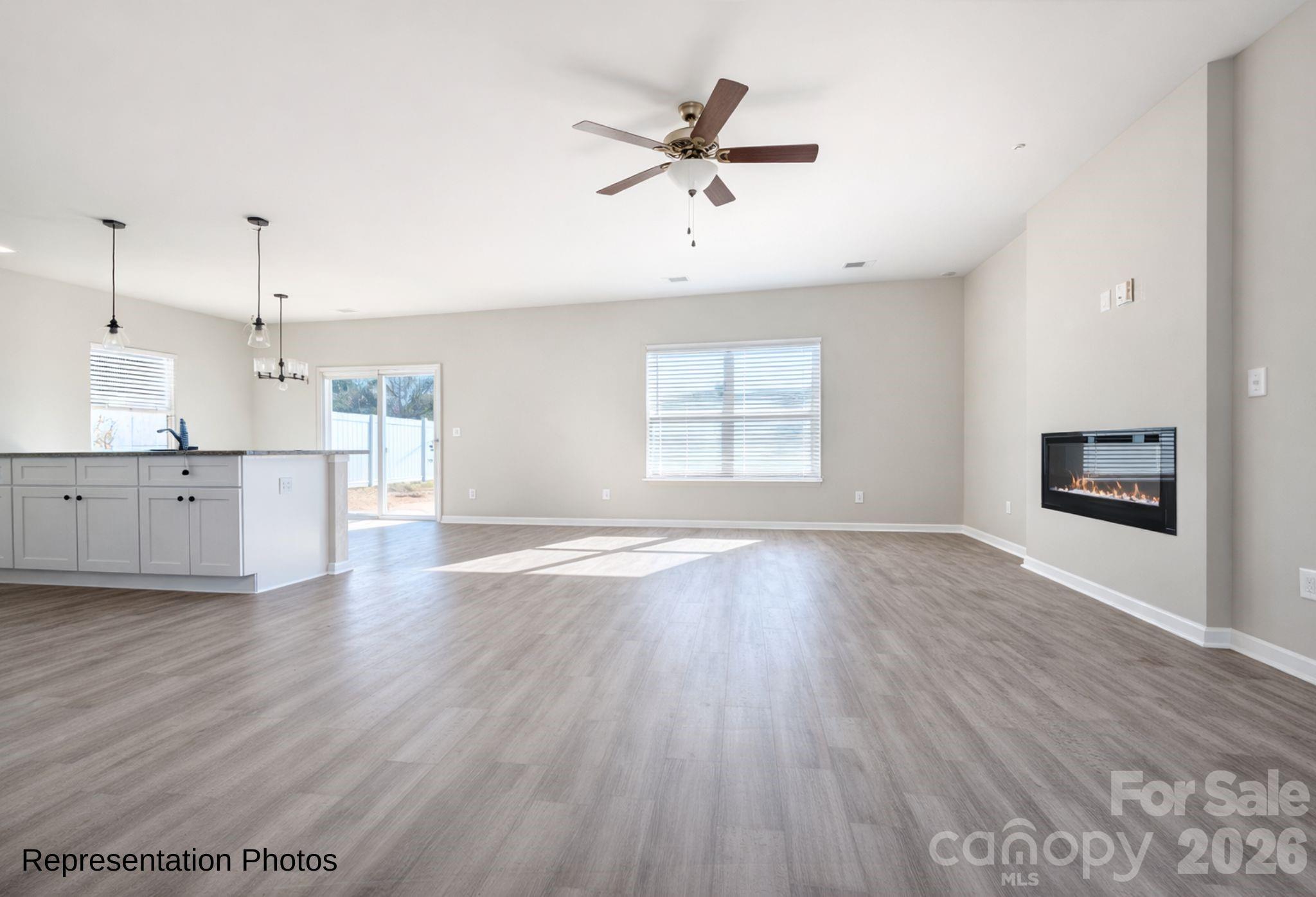 111 Pinnacle Crossing Shelby, NC 28152 - Photo 10 of 24 an empty room with wooden floor a ceiling fan and windows