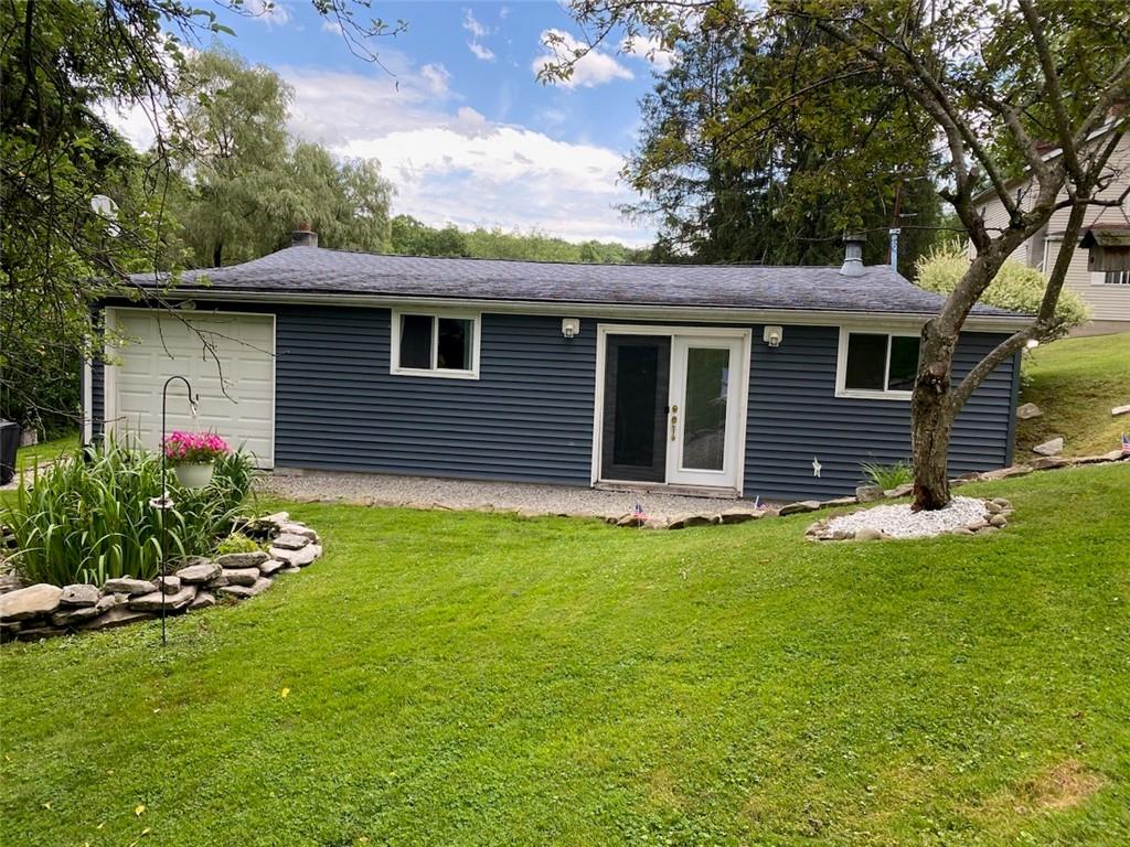 553 Browntown Road New Stanton, PA 15672 - Photo 1 of 20 a front view of a house with a garden