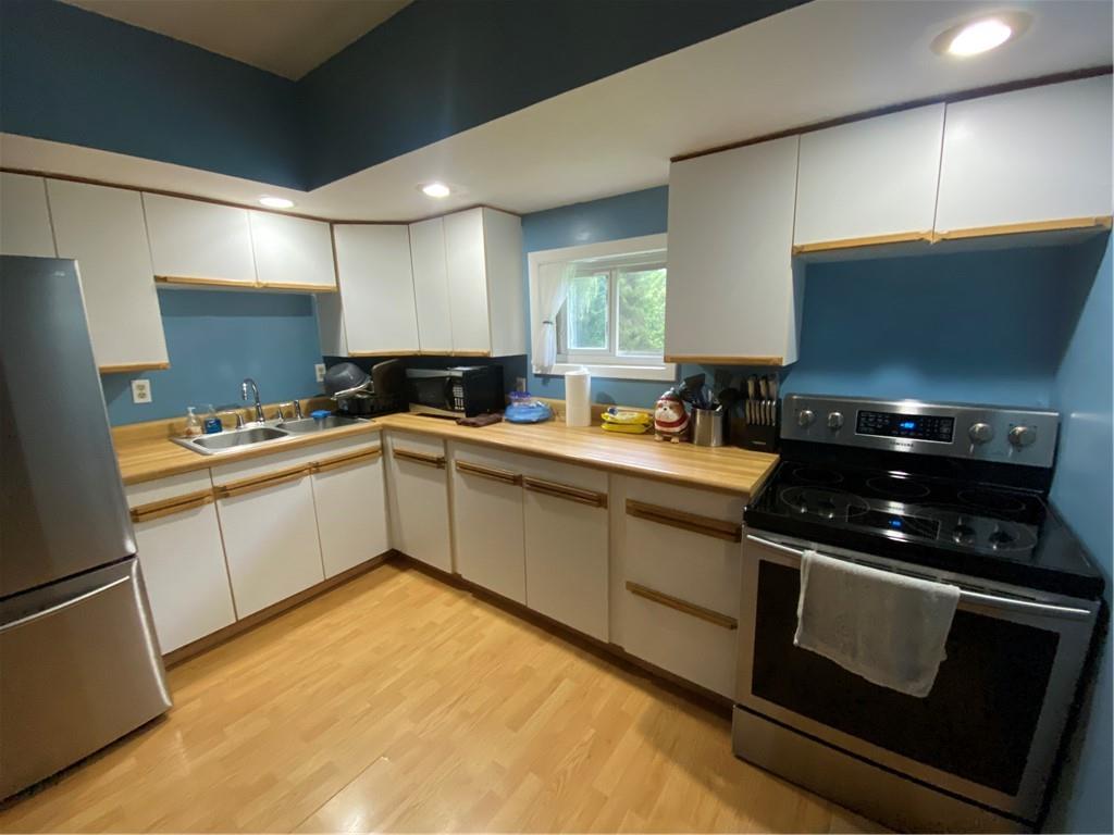 553 Browntown Road New Stanton, PA 15672 - Photo 5 of 20 a kitchen with a sink stove and cabinets