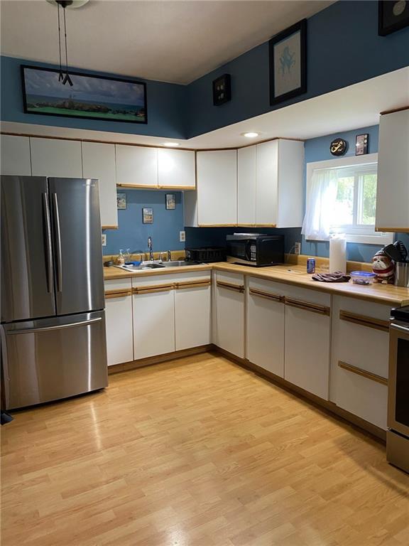 553 Browntown Road New Stanton, PA 15672 - Photo 7 of 20 a kitchen with stainless steel appliances a sink and a refrigerator