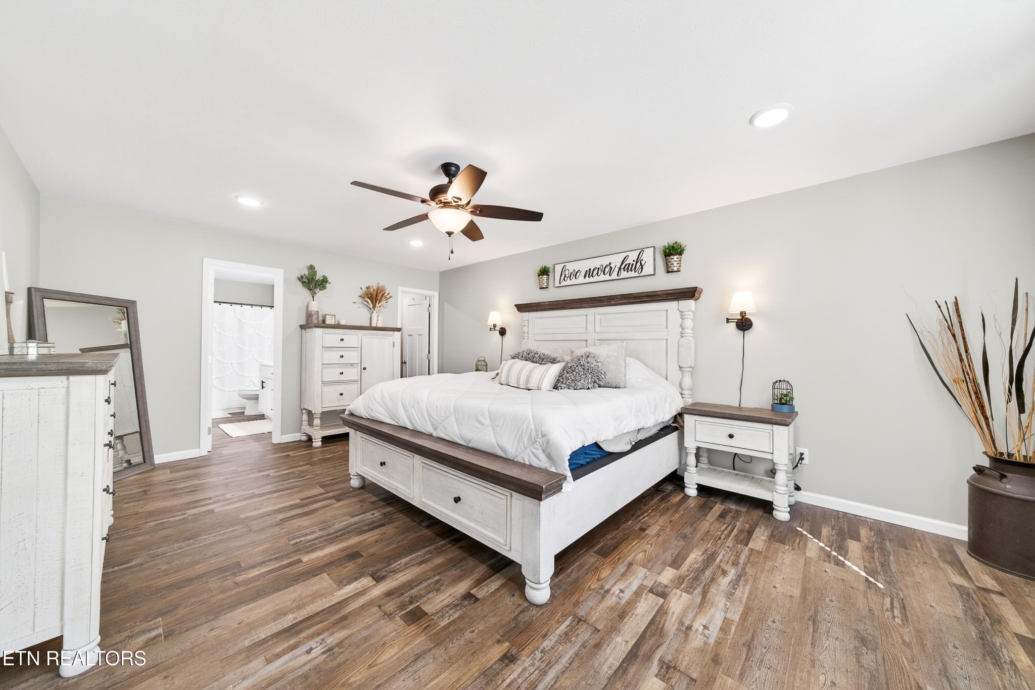 225 Peach Street Baxter, TN 38544 - Photo 17 of 35 a bedroom with a bed and a chandelier