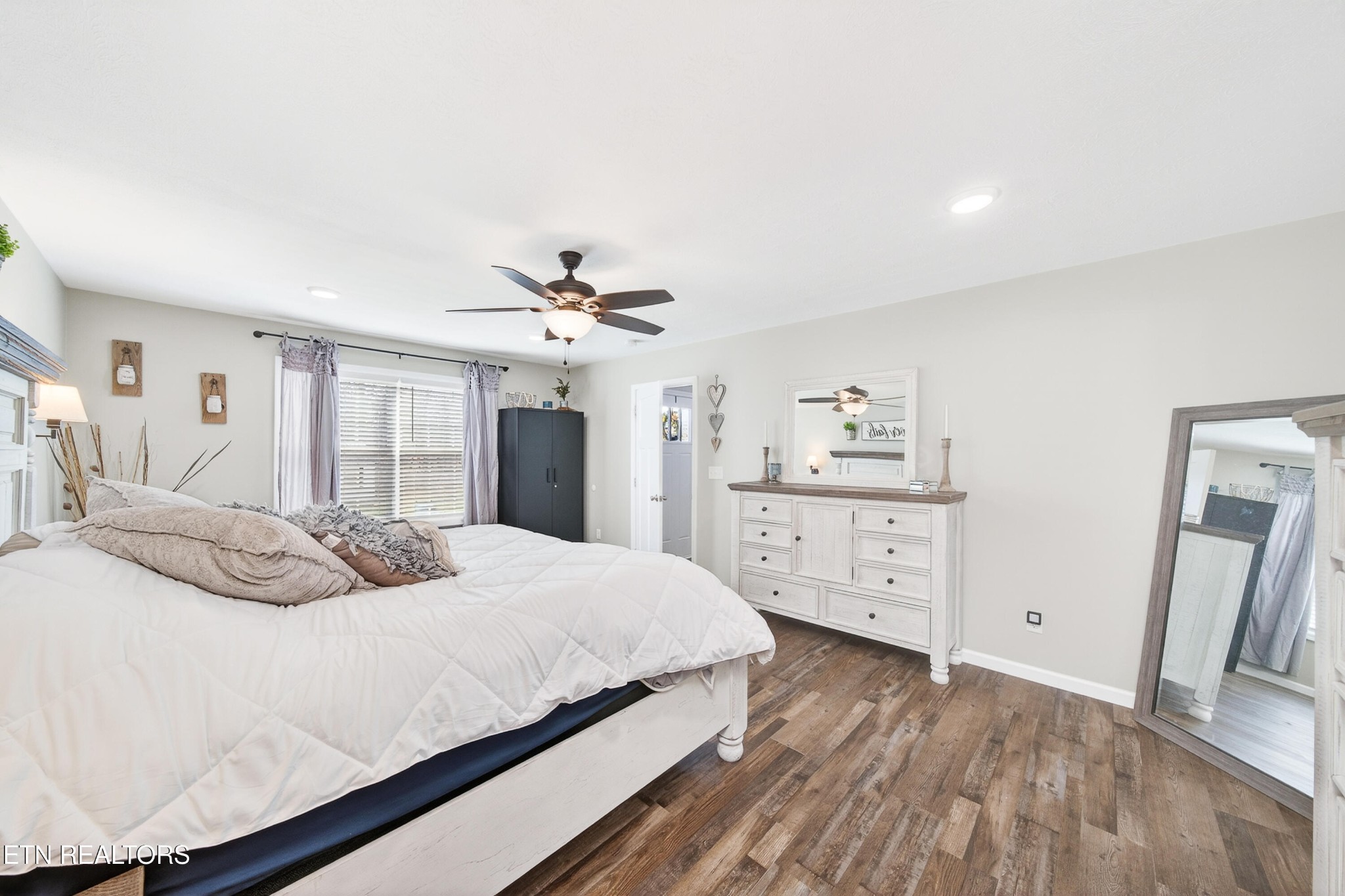 225 Peach Street Baxter, TN 38544 - Photo 18 of 35 a bedroom with a bed and a chandelier