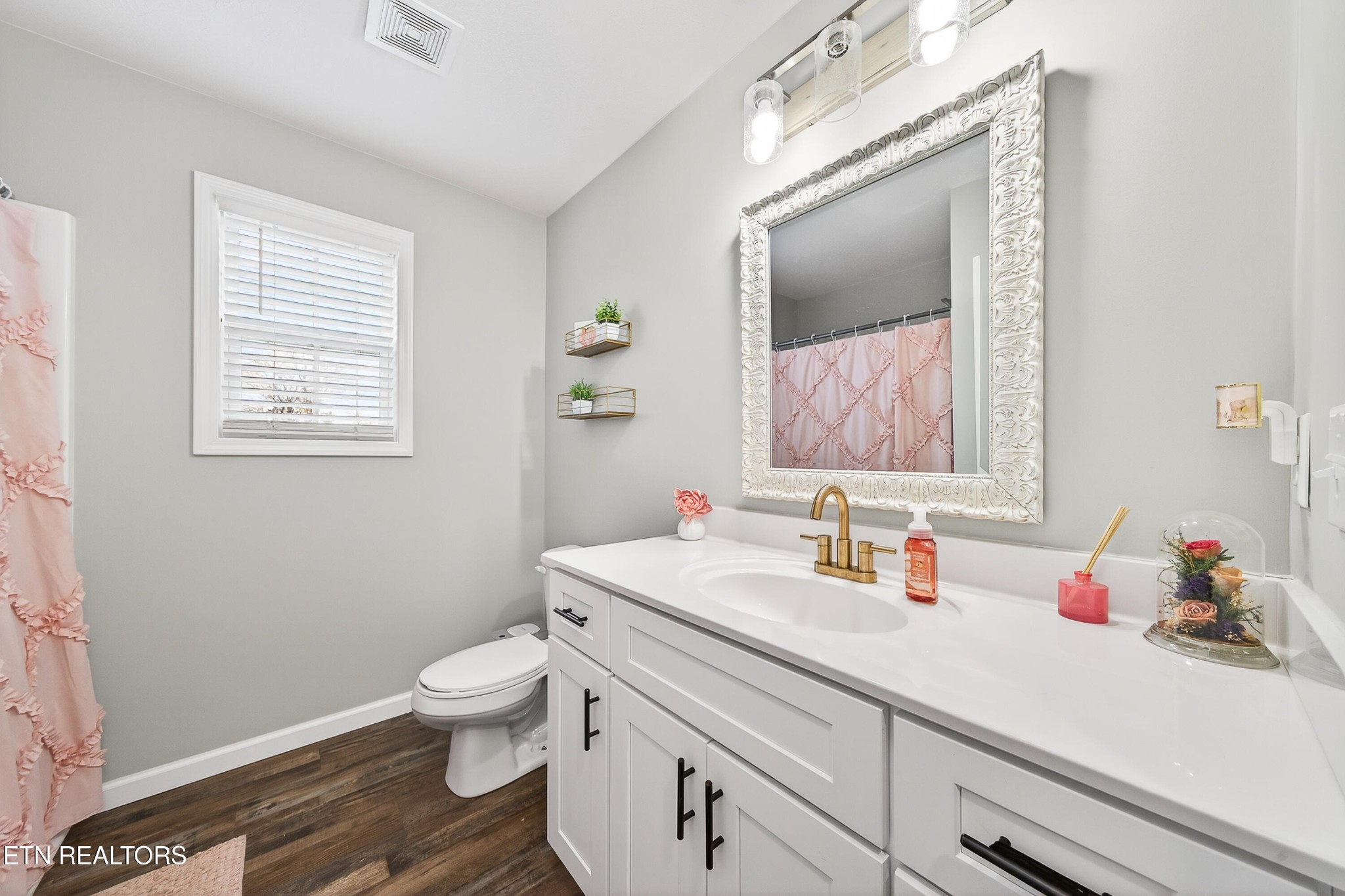 225 Peach Street Baxter, TN 38544 - Photo 21 of 35 a bathroom with a toilet sink and mirror