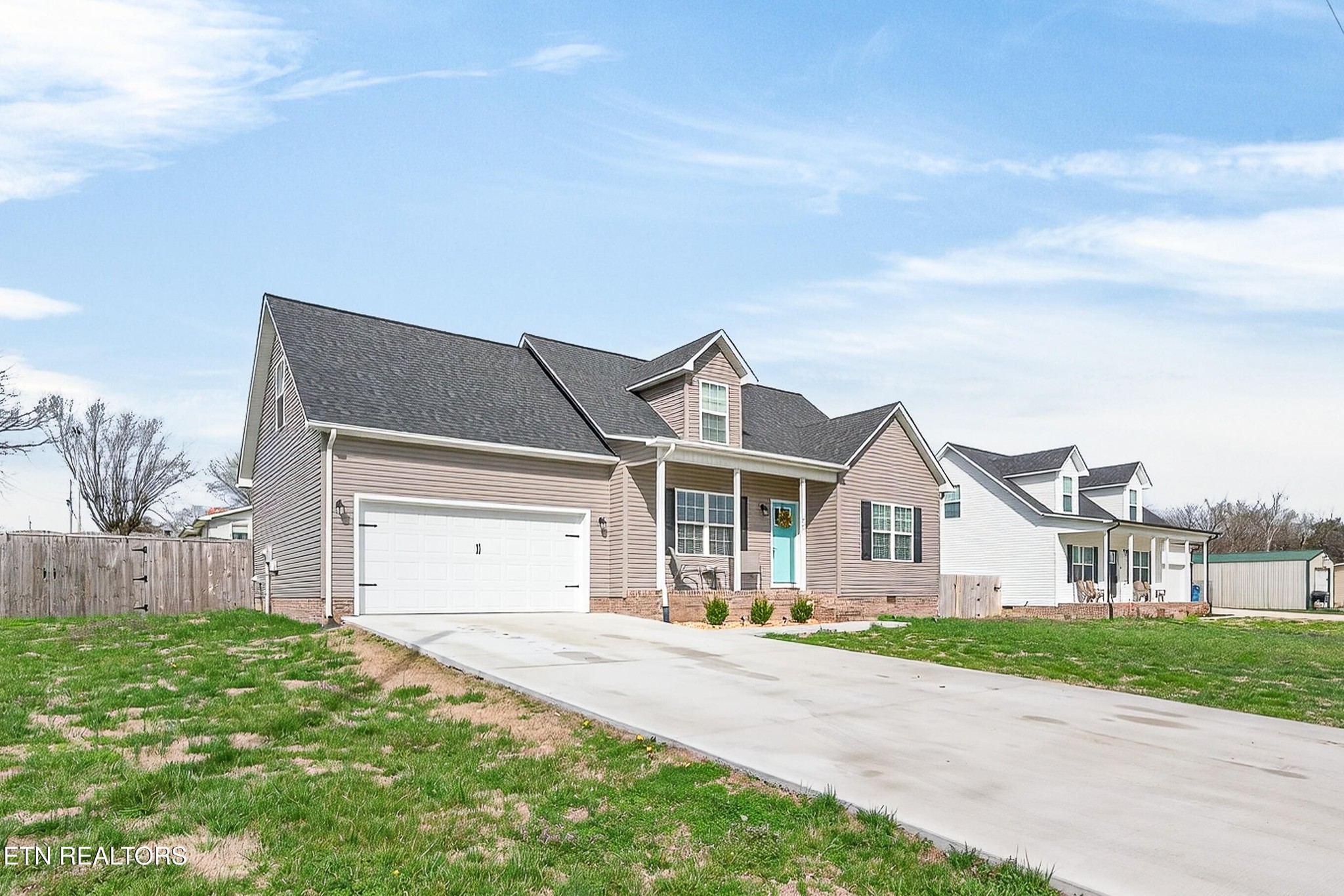 225 Peach Street Baxter, TN 38544 - Photo 27 of 35 a view of a white house with a big yard and large trees