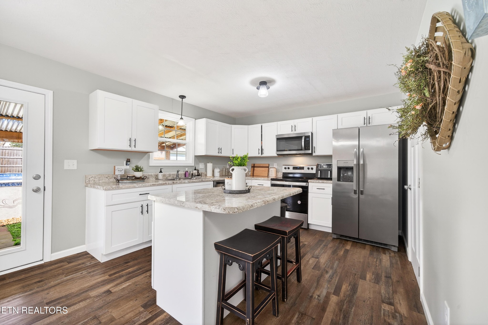 225 Peach Street Baxter, TN 38544 - Photo 9 of 35 a kitchen with a sink stainless steel appliances and white cabinets