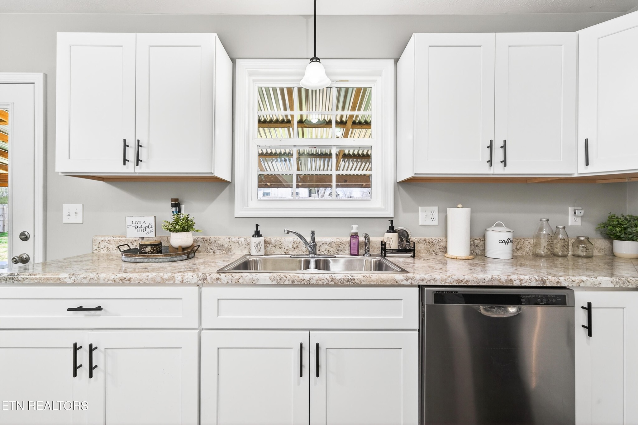 225 Peach Street Baxter, TN 38544 - Photo 10 of 35 a kitchen with granite countertop white cabinets and white appliances