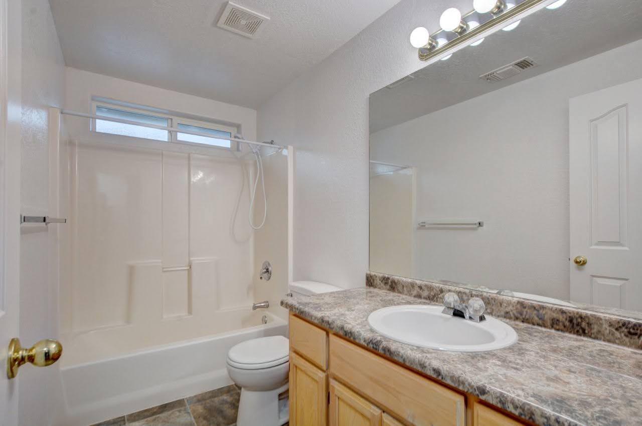 417 Crystal Drive Eagle Point, OR 97524 - Photo 22 of 35 a bathroom with a granite countertop sink toilet and shower