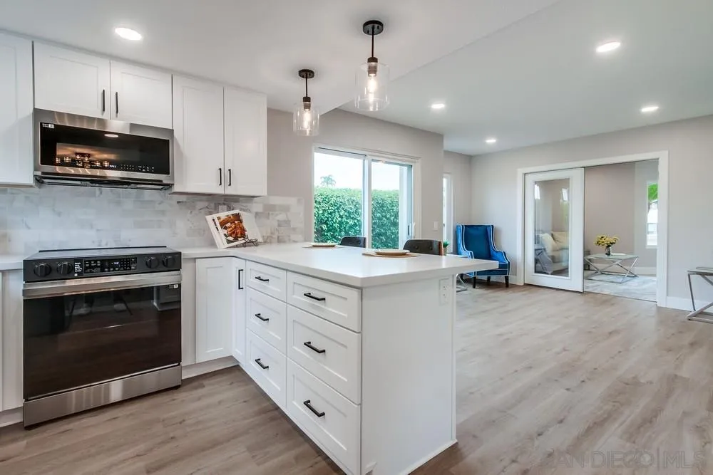 1278 Avenida Miguel Encinitas, CA 92024 - Photo 16 of 47 a kitchen with stainless steel appliances a stove sink and microwave