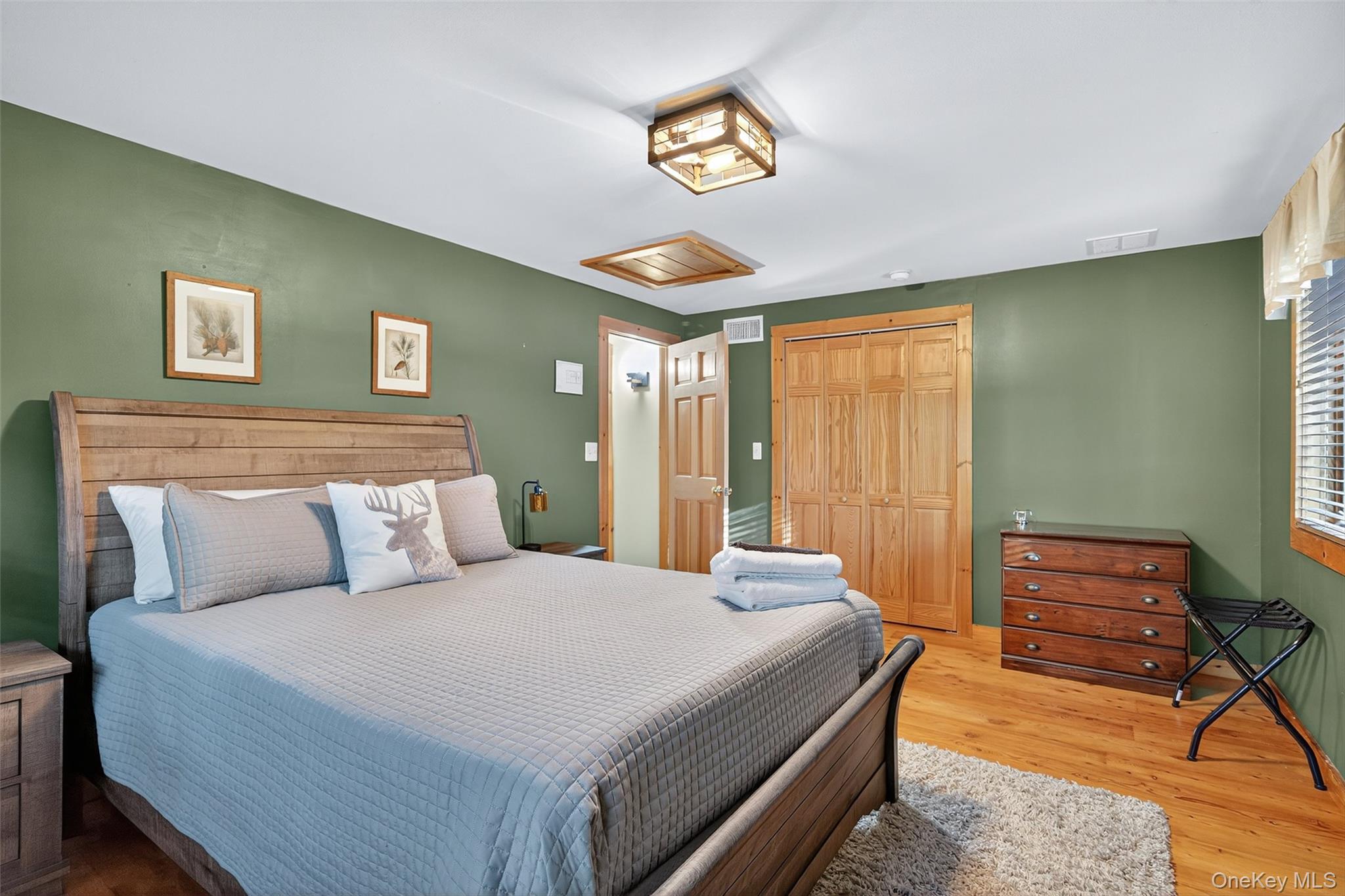 165 Cascade Road Warwick, NY 10990 - Photo 31 of 49 a bedroom with a bed and a chandelier