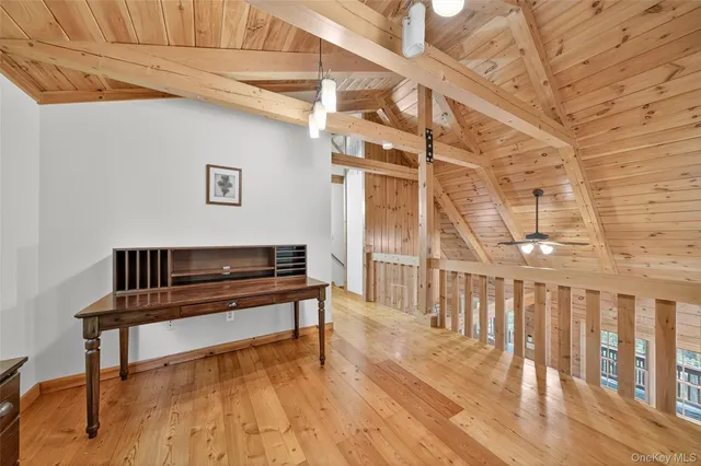a bedroom with a bed and a tv on the dresser