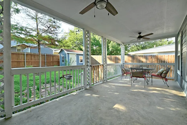 a view of a porch with chairs and backyard