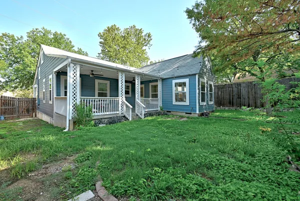a view of a house with yard and a garden