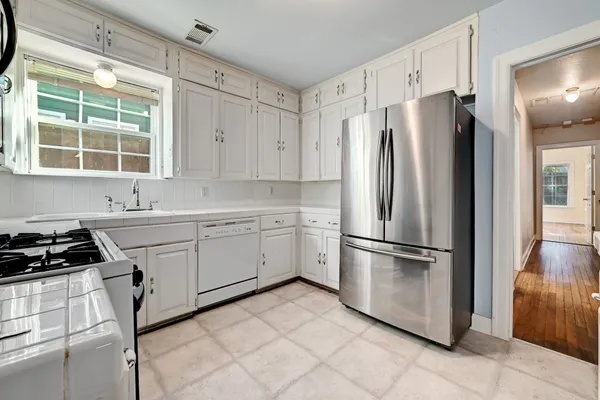 a kitchen with appliances cabinets and a sink