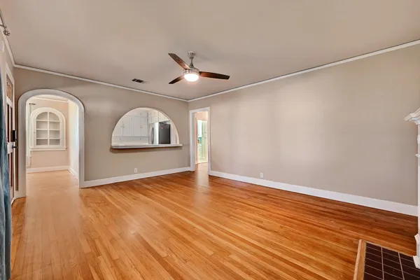 a view of empty room with wooden floor