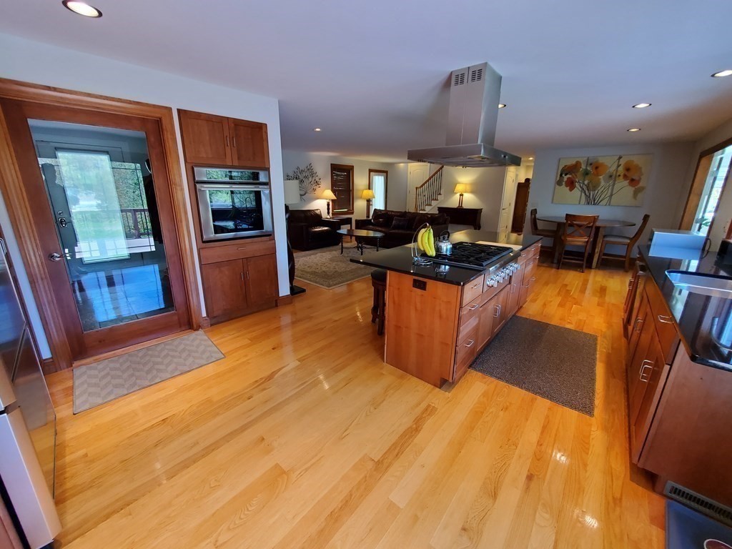12 Beaman Road Sterling, MA 01564 - Photo 14 of 40 a living room with furniture a flat screen tv and a floor to ceiling window
