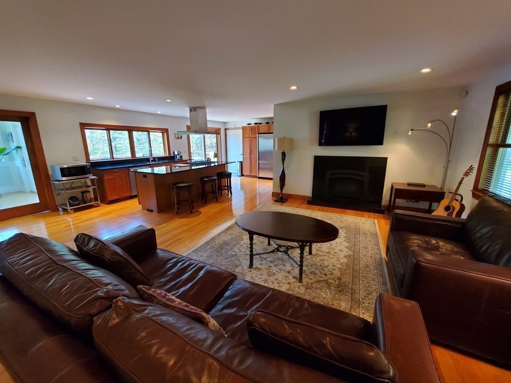 12 Beaman Road Sterling, MA 01564 - Photo 19 of 40 a living room with furniture fireplace and a flat screen tv