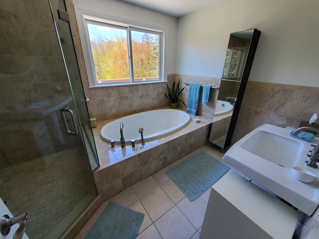 12 Beaman Road Sterling, MA 01564 - Photo 30 of 40 a bath tub sitting in a bathroom next to a window