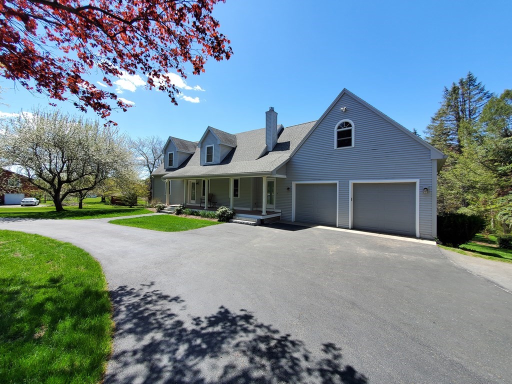 12 Beaman Road Sterling, MA 01564 - Photo 3 of 40 a front view of a house with a garden and trees