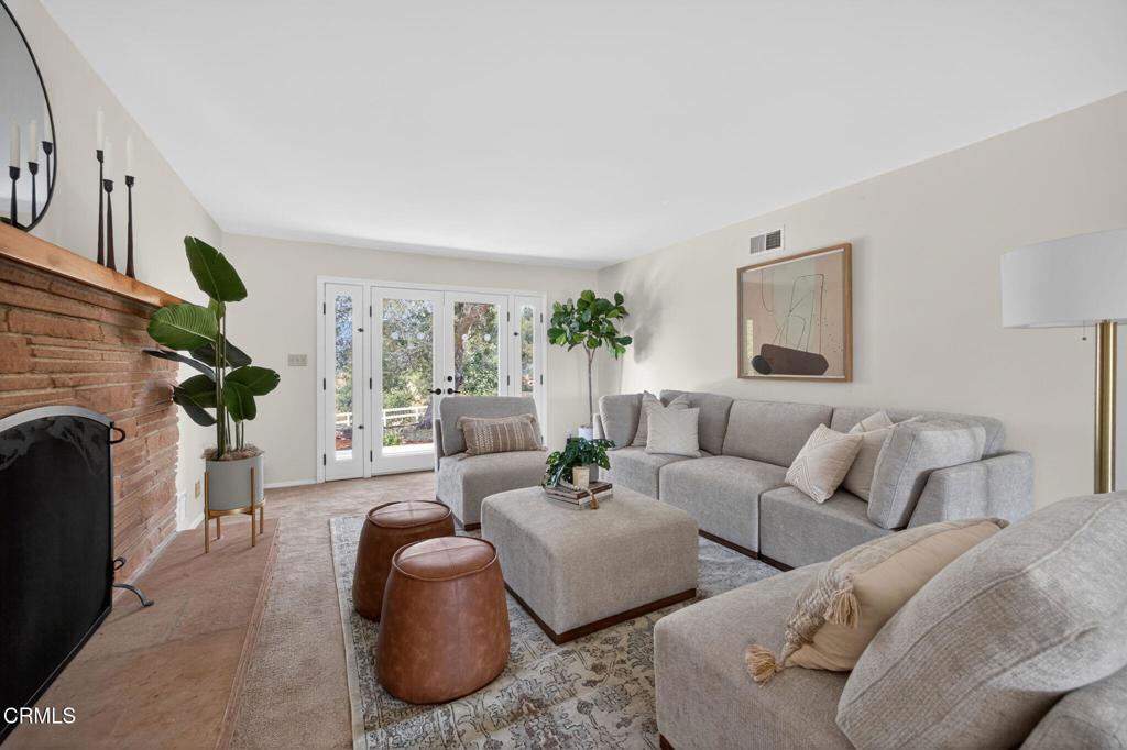 98 Howard Avenue Oak View, CA 93022 - Photo 12 of 72 a living room with furniture a large window and a fireplace