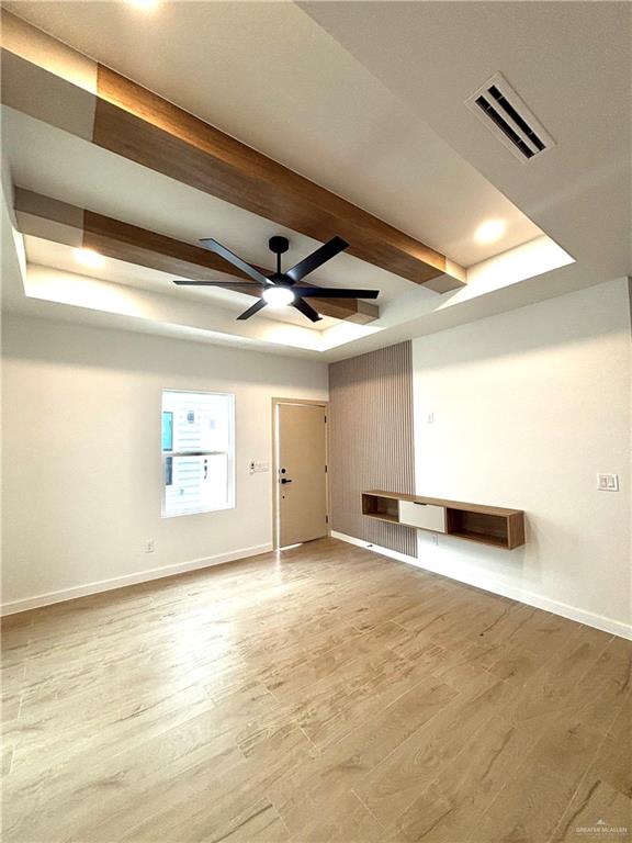 3 Estevan Street Mission, TX 78573 - Photo 20 of 22 Spacious interior featuring a recessed ceiling with wood-finish beams, a modern ceiling fan, and recessed lighting