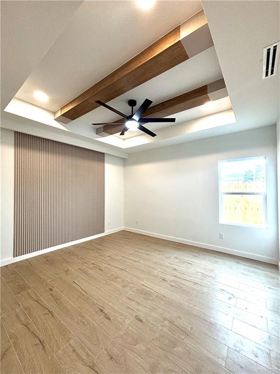 3 Estevan Street Mission, TX 78573 - Photo 2 of 22 Recessed ceiling with wood-finish beams, integrated lighting, and a modern ceiling fan