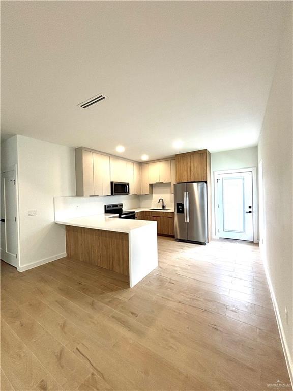 3 Estevan Street Mission, TX 78573 - Photo 22 of 22 Modern kitchen featuring light wood-finish cabinetry, stainless steel appliances, white countertops, and recessed lighting
