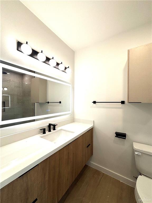 3 Estevan Street Mission, TX 78573 - Photo 8 of 22 Contemporary bathroom featuring a floating wood-finish vanity with a white countertop and integrated sink