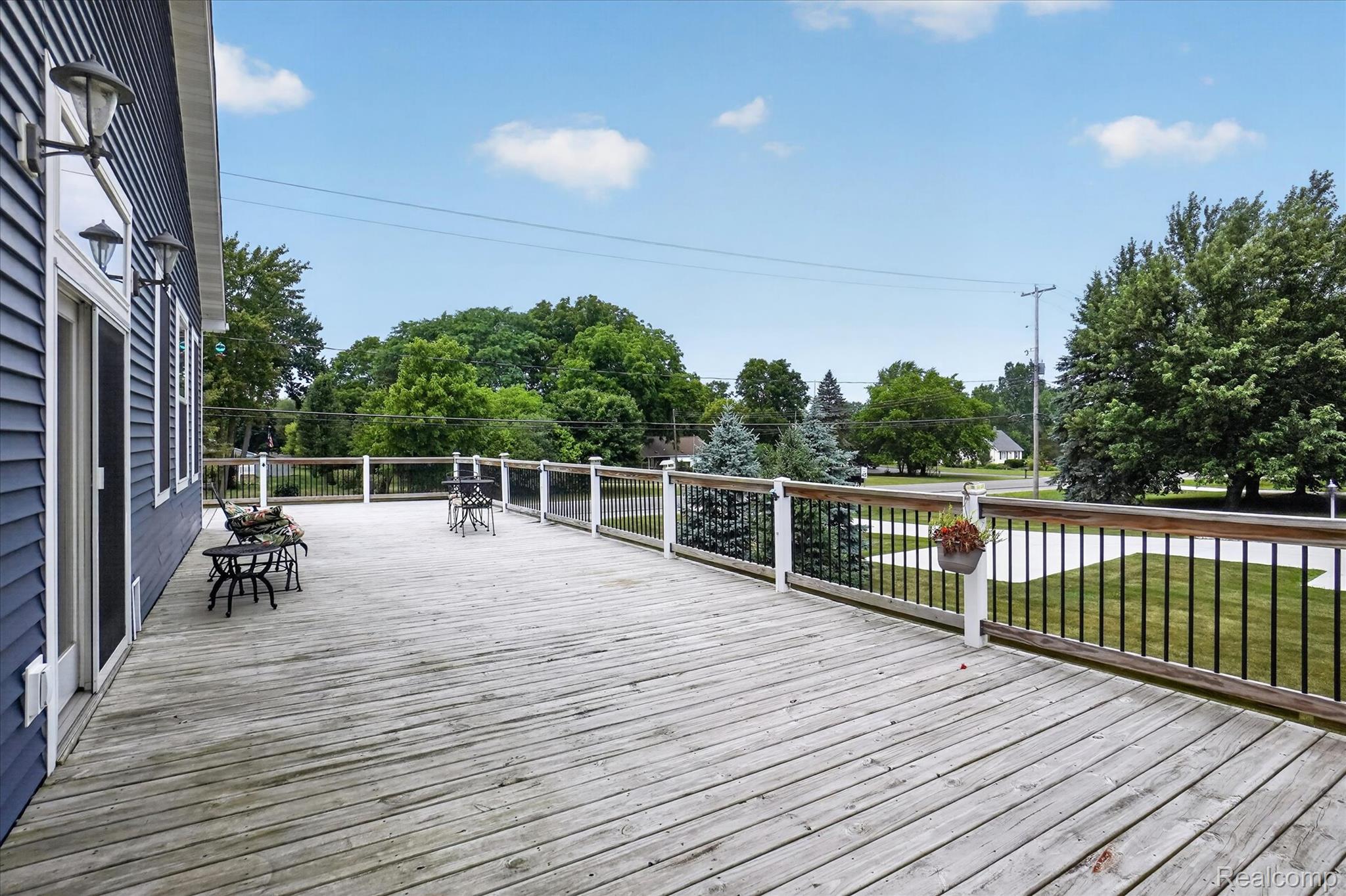 6524 Kelly Road Flushing, MI 48433 - Photo 38 of 47 Expansive wood deck with white and black railings, offering direct access to the interior
