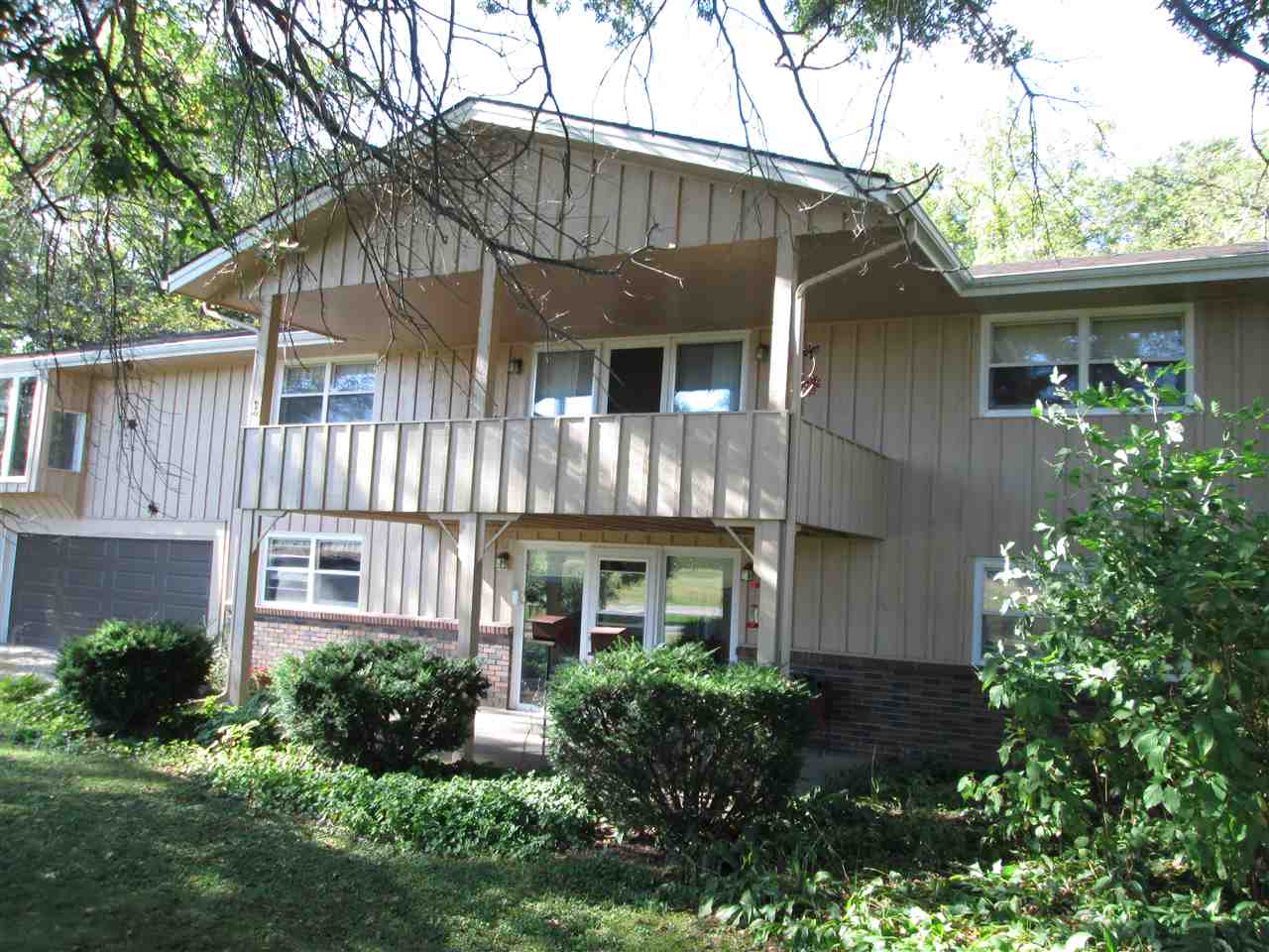 10217 Yale Bridge Road Rockton, IL 61072 - Photo 1 of 25 a view of a house with brick walls and a yard with plants