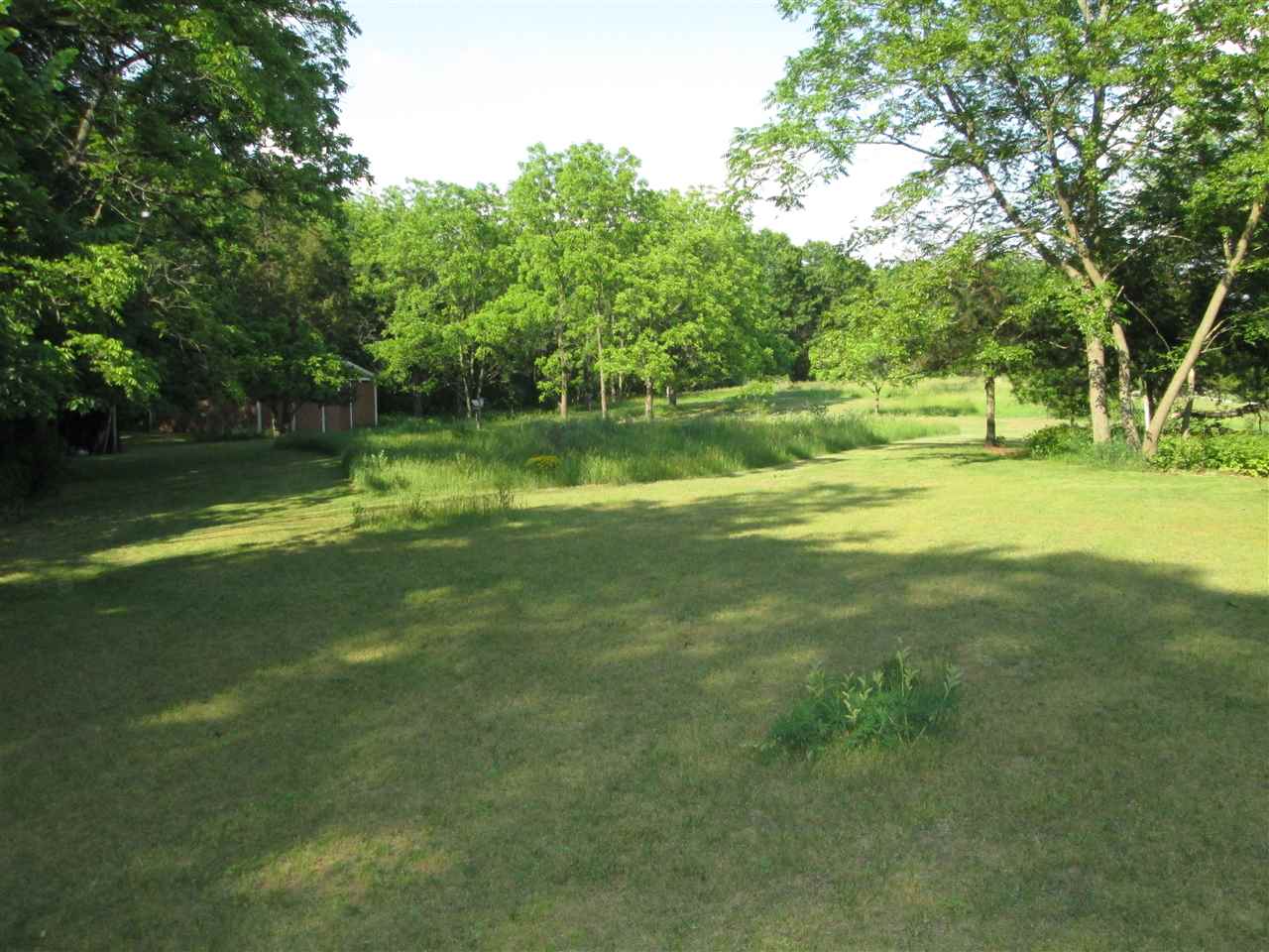 10217 Yale Bridge Road Rockton, IL 61072 - Photo 21 of 25 a view of a green field with wooden fence