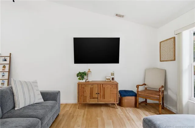 a living room with furniture ceiling fan and a rug