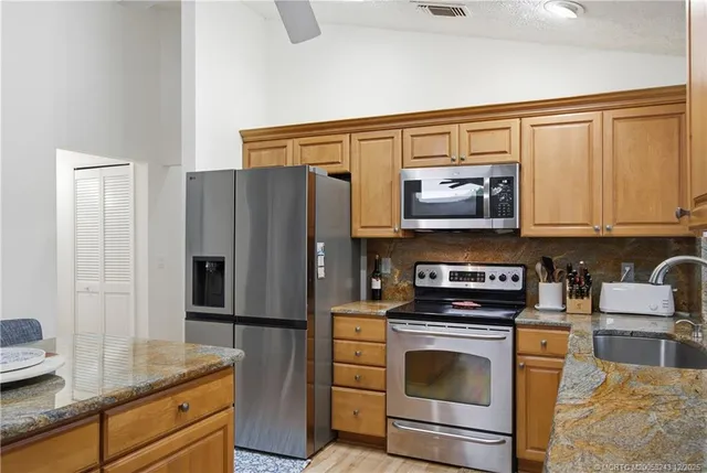 a dining room with furniture potted plants and wooden floor