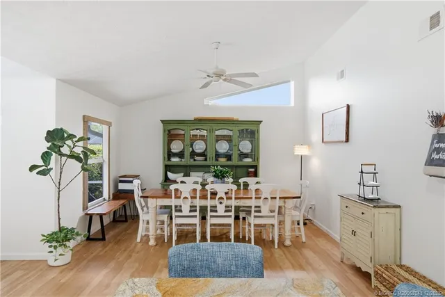 a bedroom with a bed a window and a chandelier