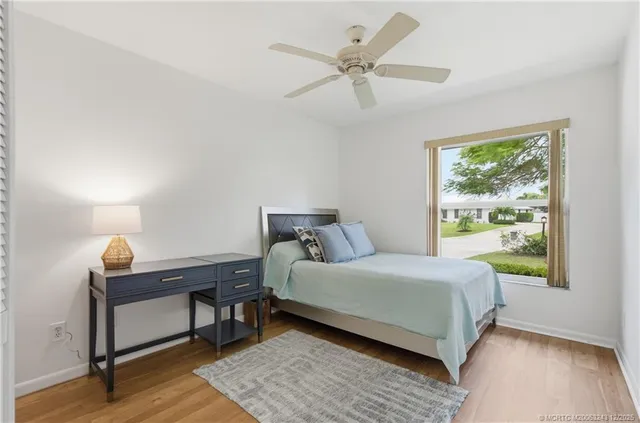 a bedroom with a bed tv and a window